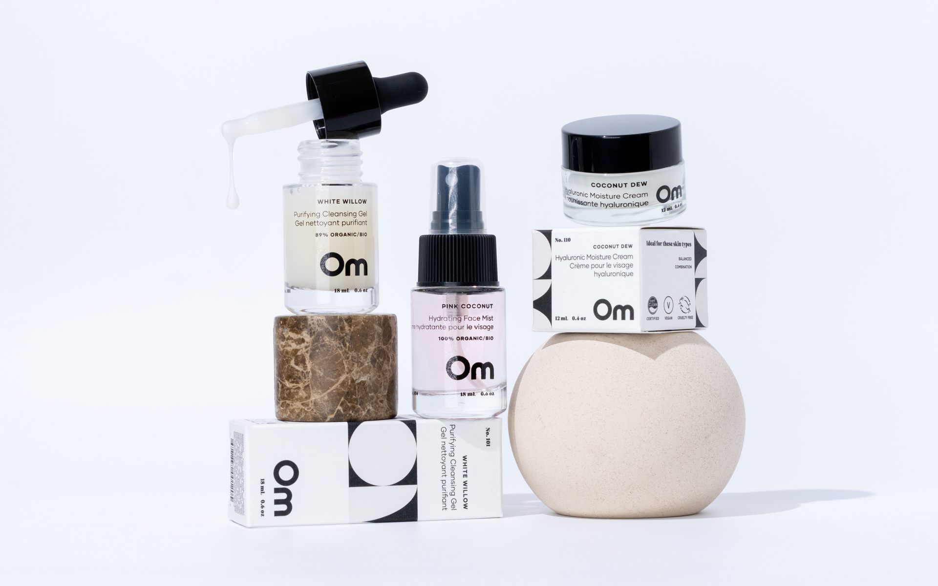 Collection of skincare products with 'Om' branding on a white background