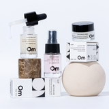 Collection of skincare products with 'Om' branding on a white background